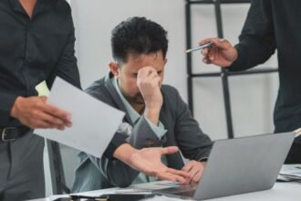 Workplace toughness shown by a leader guiding a team through a demanding discussion with clarity, discipline and respect