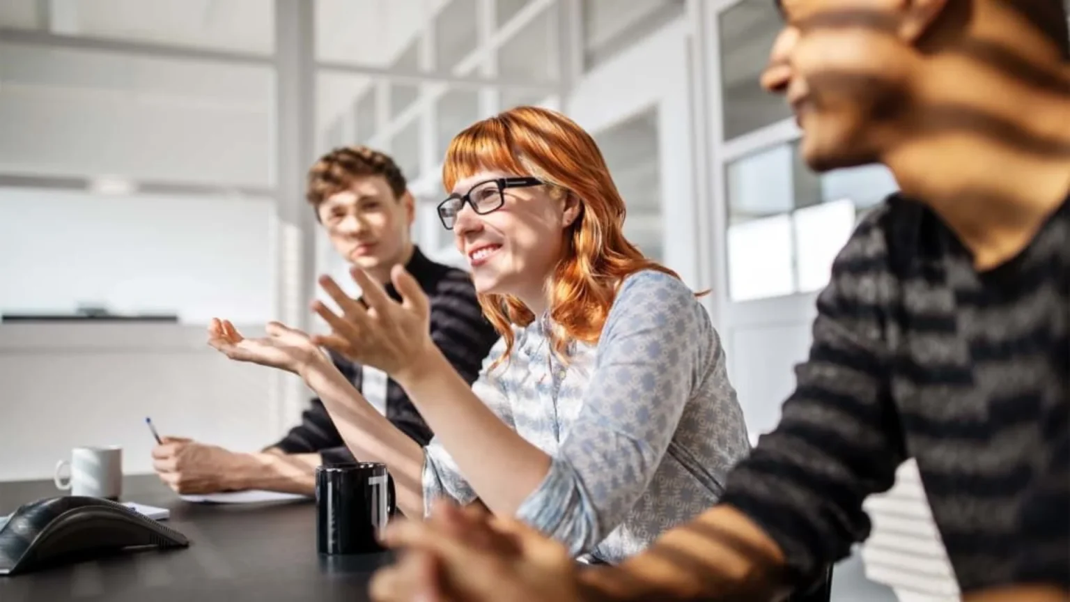 Emotional intelligence helping colleagues manage defensiveness and communicate constructively during a difficult workplace conversation.